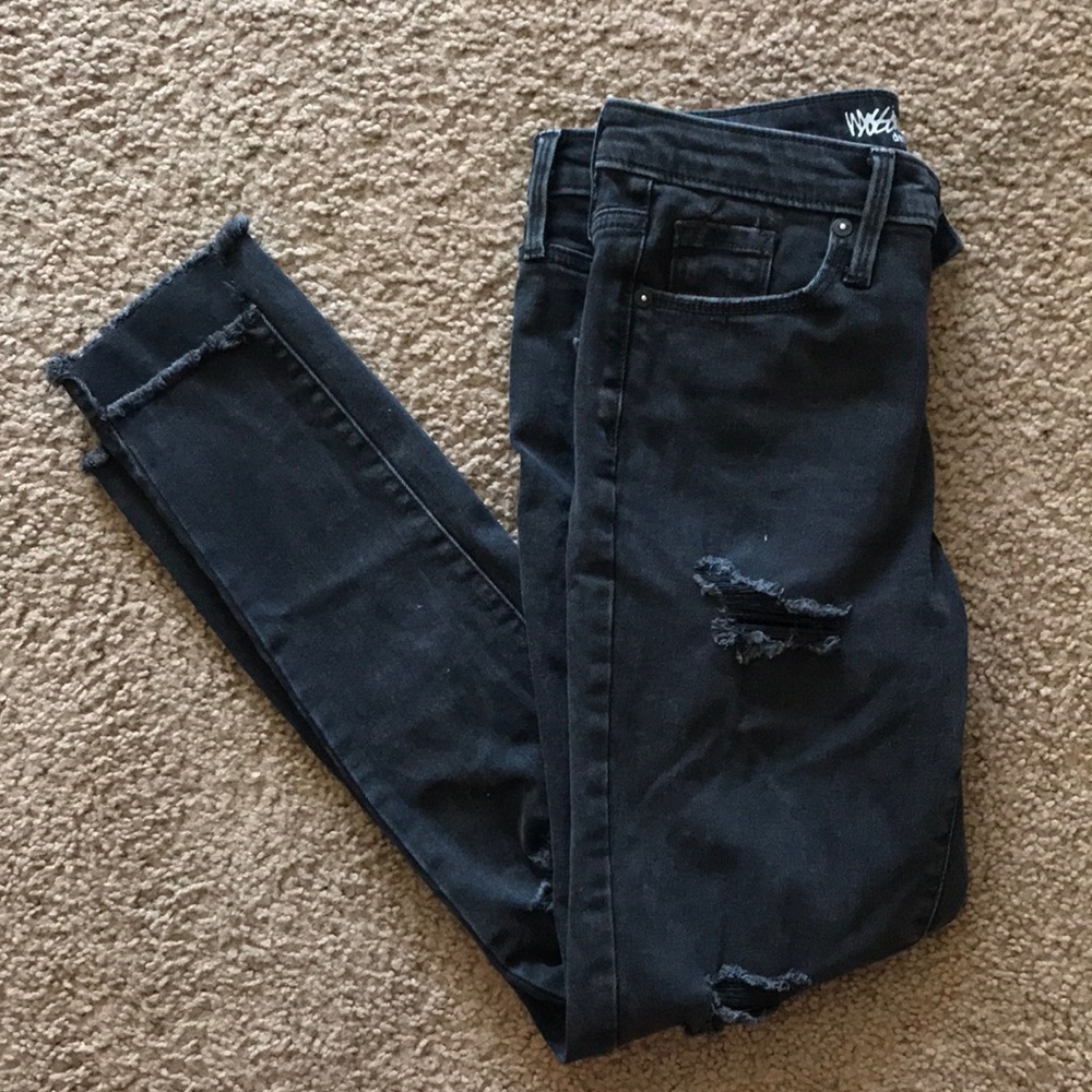 Distressed black skinny jeans.
